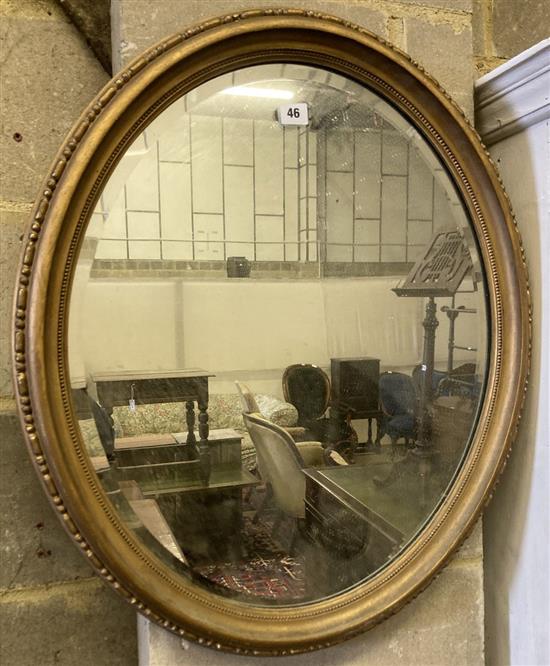 An early 20th century oval giltwood and gesso wall mirror, width 60cm height 70cm